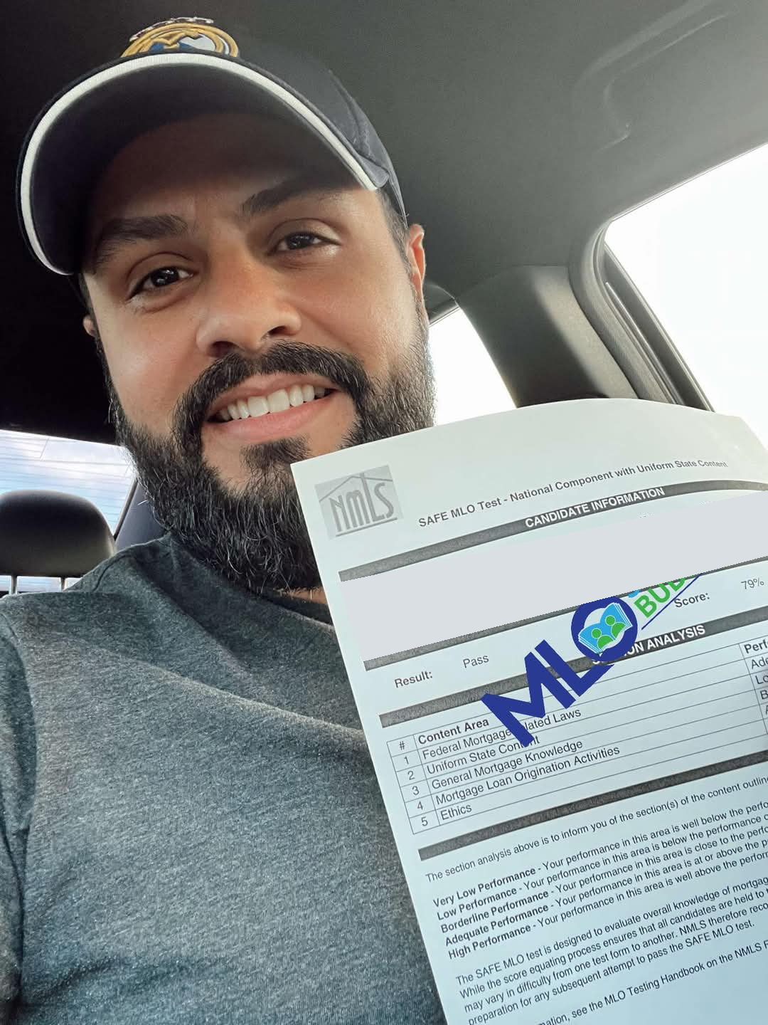 Student holding a SAFE MLO Exam pass result; candidate information obscured
